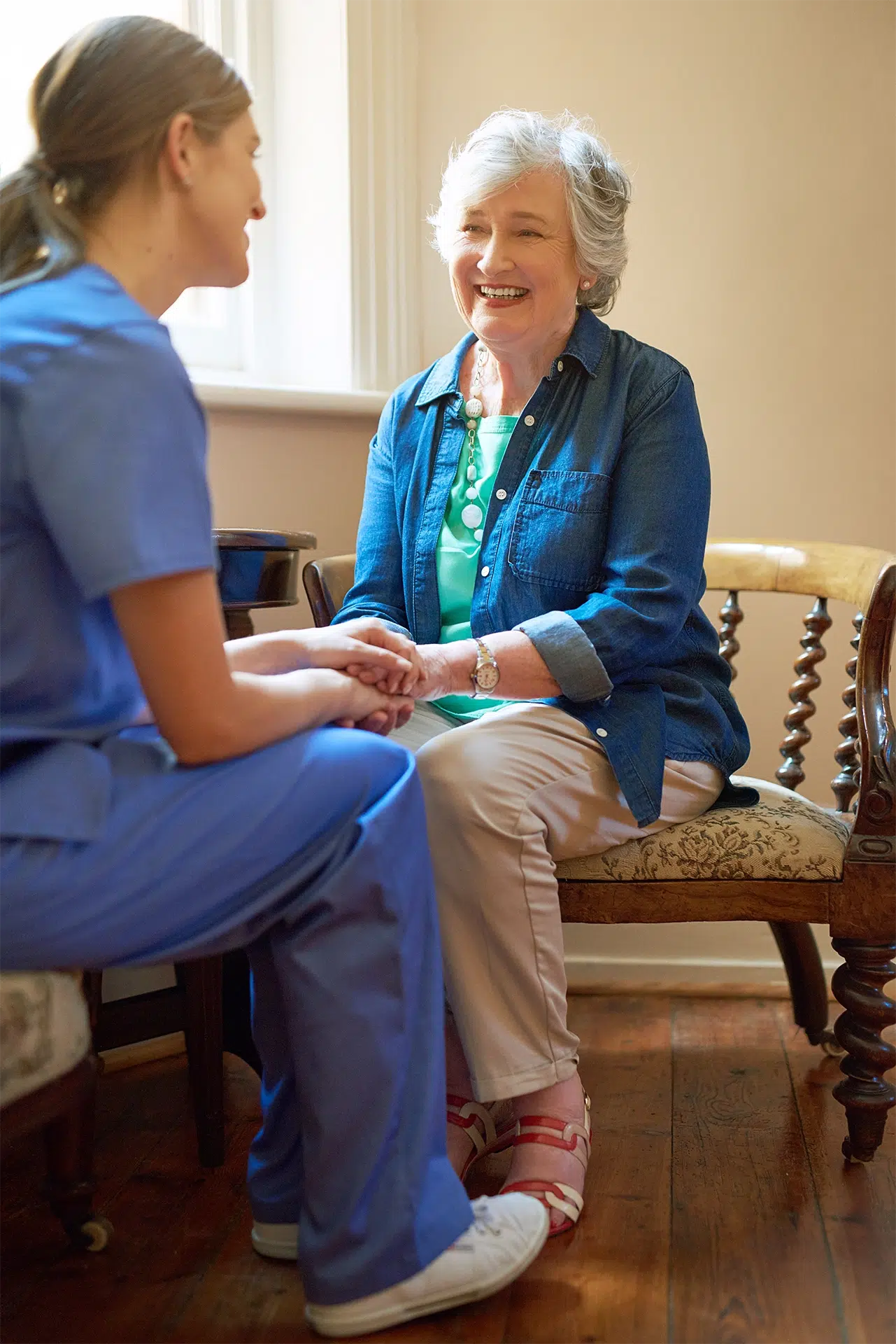 Caregiver providing in-home care and companionship support to an elderly woman at home, helping maintain independence and quality of life